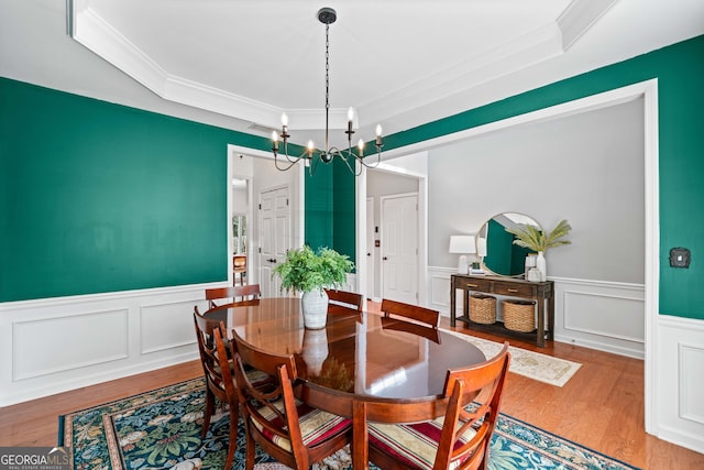 3810 Branch Bluff Ln, Cumming, GA 30040 - dining area with wood finished floors, a chandelier, wainscoting, and crown molding