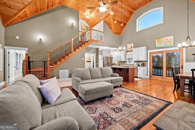 153 Whistle Pig Ter, Blairsville, GA 30512 - living area featuring light wood-type flooring, visible vents, ceiling fan with notable chandelier, wooden ceiling, and stairs