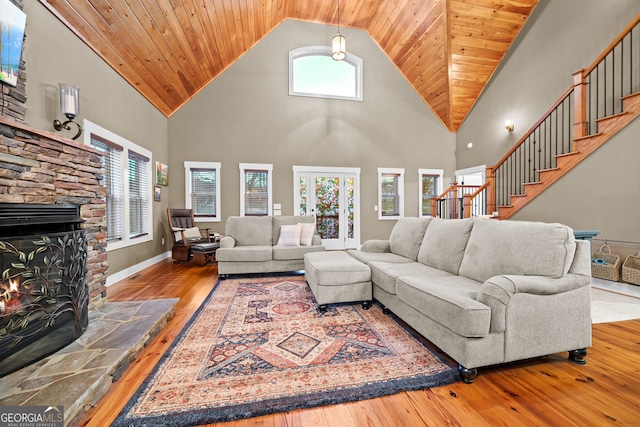 153 Whistle Pig Ter, Blairsville, GA 30512 - living room with baseboards, stairs, a stone fireplace, wooden ceiling, and hardwood / wood-style flooring