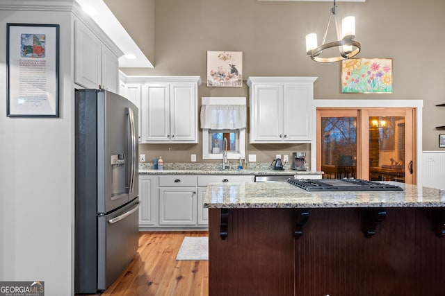 153 Whistle Pig Ter, Blairsville, GA 30512 - kitchen featuring a kitchen bar, stainless steel fridge, white cabinets, and gas stovetop