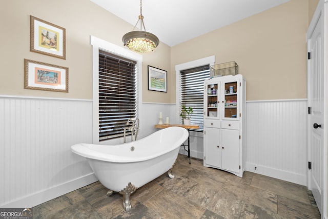153 Whistle Pig Ter, Blairsville, GA 30512 - bathroom featuring a freestanding tub, stone finish floor, a chandelier, and wainscoting