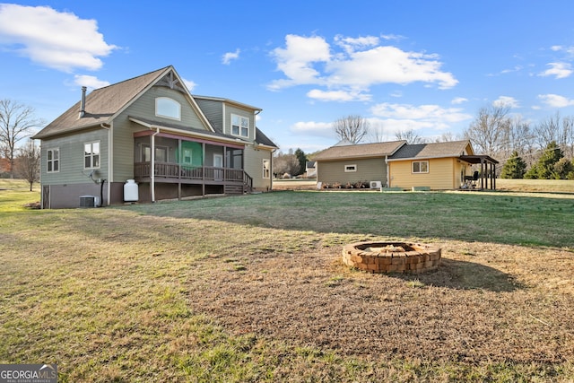 153 Whistle Pig Ter, Blairsville, GA 30512 - rear view of house featuring a yard, a sunroom, central air condition unit, and an outdoor fire pit