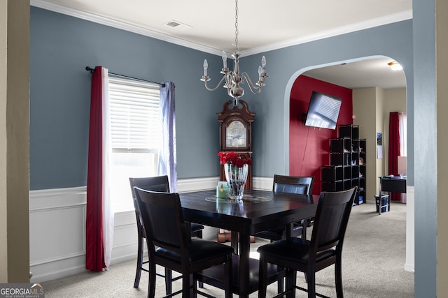 dining room with visible vents, arched walkways, ornamental molding, and carpet flooring