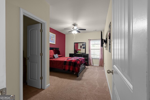 carpeted bedroom featuring baseboards and ceiling fan