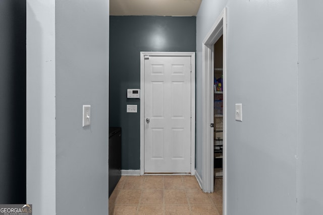 hallway featuring baseboards