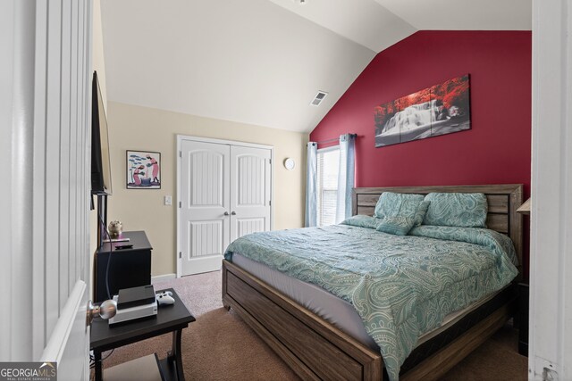 bedroom featuring lofted ceiling, carpet, visible vents, and a closet