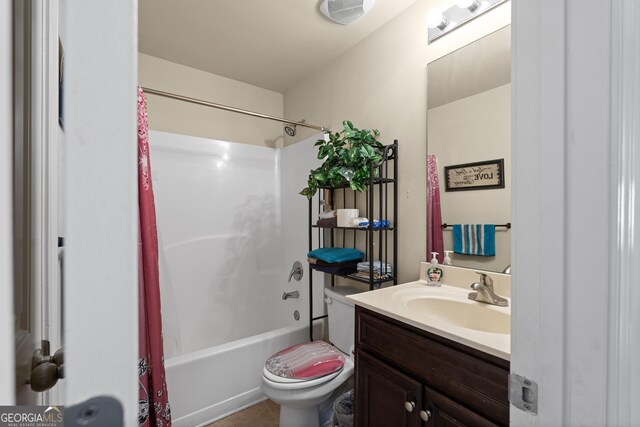 bathroom with shower / bath combination with curtain, vanity, and toilet