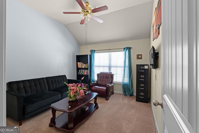 carpeted living room featuring baseboards, ceiling fan, and vaulted ceiling