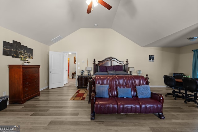 bedroom with a ceiling fan, wood finished floors, visible vents, baseboards, and vaulted ceiling