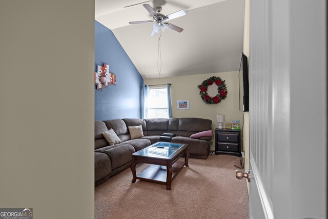 living area with light carpet, a ceiling fan, and vaulted ceiling