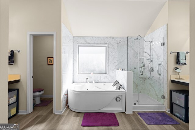 bathroom featuring a marble finish shower, a garden tub, wood finished floors, and toilet