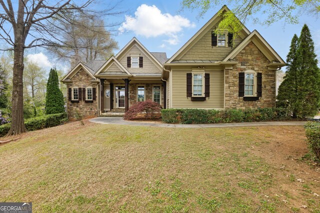 craftsman-style home with stone siding and roof with shingles