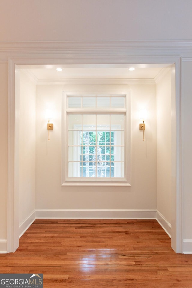 spare room featuring crown molding, light wood-style flooring, recessed lighting, and baseboards
