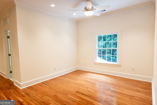 spare room featuring ceiling fan, baseboards, light wood-style flooring, and crown molding