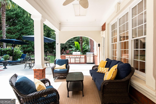 view of patio with fence, an outdoor kitchen, ceiling fan, outdoor lounge area, and a grill