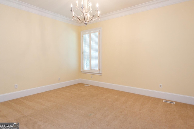 carpeted empty room featuring a notable chandelier, crown molding, and baseboards
