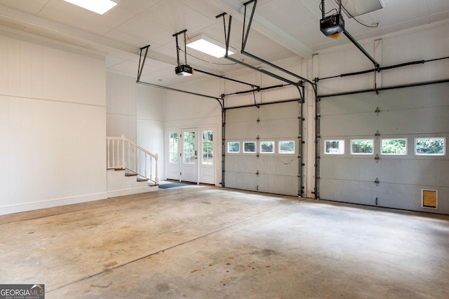 garage with a garage door opener and french doors