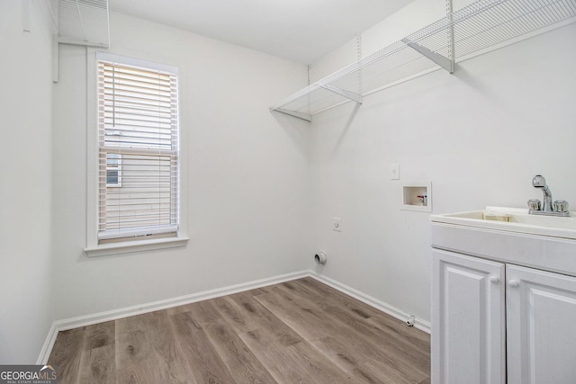 4319 Alysheba Dr, Fairburn, GA 30213 - laundry room with washer hookup, cabinet space, wood finished floors, and hookup for an electric dryer