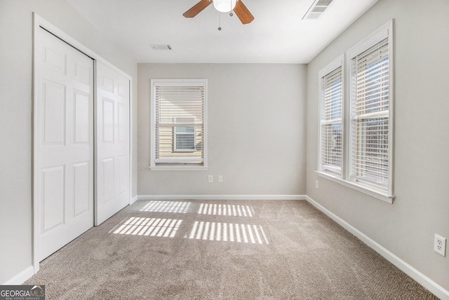 4319 Alysheba Dr, Fairburn, GA 30213 - unfurnished bedroom with carpet flooring, multiple windows, and a closet