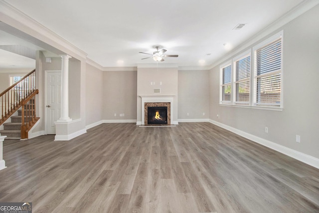 4319 Alysheba Dr, Fairburn, GA 30213 - unfurnished living room featuring a ceiling fan, stairway, light wood-style flooring, ornamental molding, and a fireplace