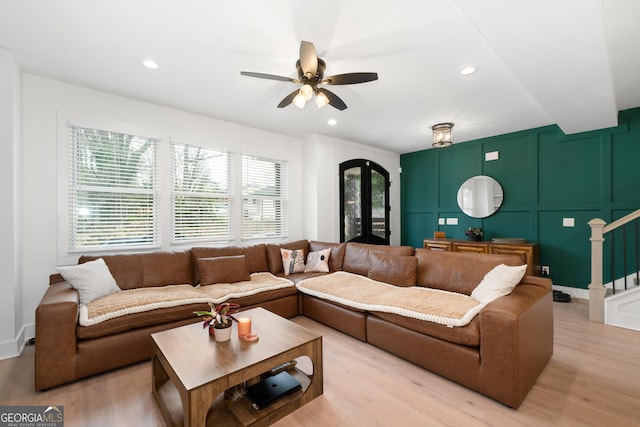 1290 Westboro Dr SW, Atlanta, GA 30310 - living area featuring stairs, french doors, light wood-style floors, a decorative wall, and a ceiling fan