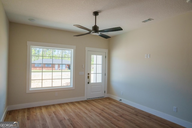42 Walton Way, Hazlehurst, GA 31539 - doorway featuring wood finished floors, a textured ceiling, and ceiling fan