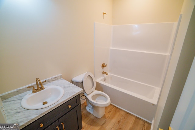 42 Walton Way, Hazlehurst, GA 31539 - full bath with wood finished floors, vanity, and shower / bathtub combination