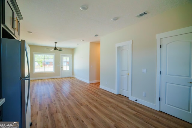 42 Walton Way, Hazlehurst, GA 31539 - unfurnished living room with light wood finished floors and ceiling fan