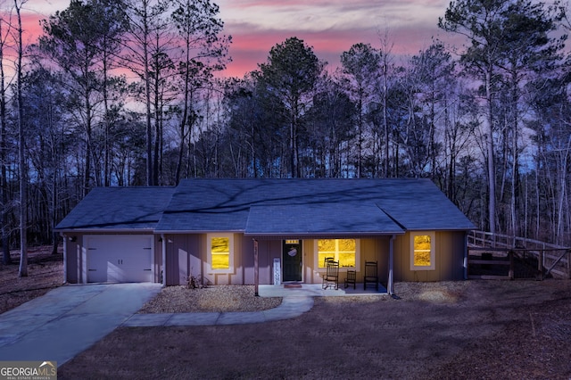 132 Pinnacle Way, Carrollton, GA 30117 - view of front facade with concrete driveway, an attached garage, covered porch, and board and batten siding