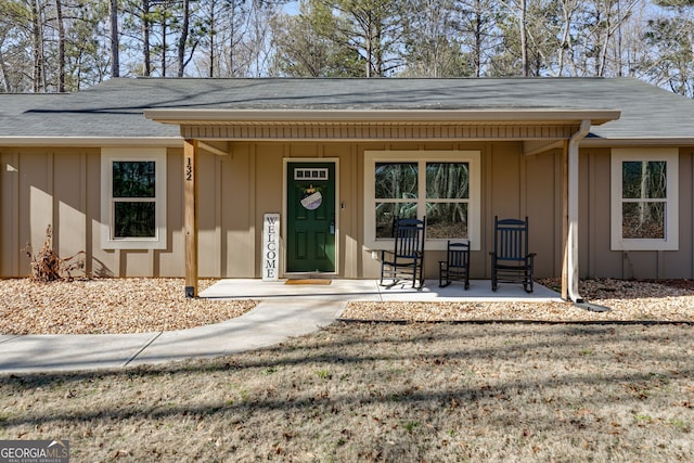 132 Pinnacle Way, Carrollton, GA 30117 - property entrance with a porch, board and batten siding, and a shingled roof