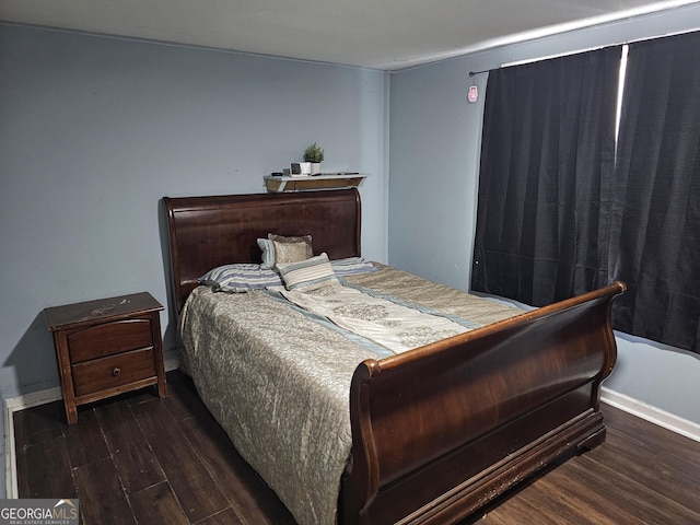 bedroom featuring baseboards and wood finished floors