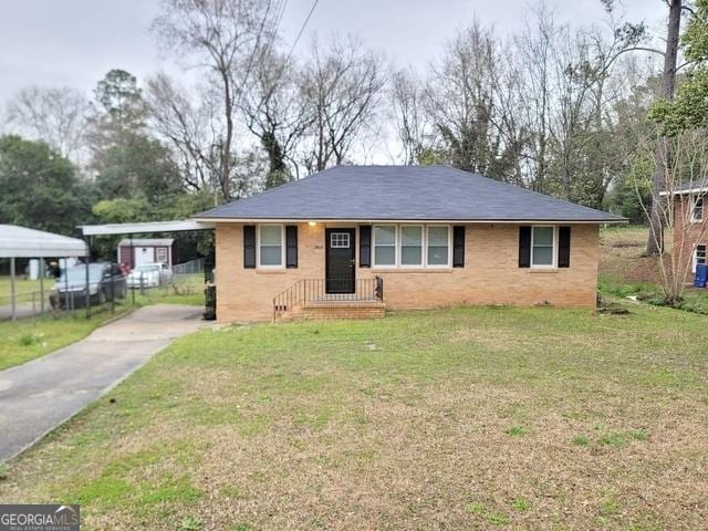 1151 N Beddingfield Dr, Macon, GA 31206 - view of front of house with driveway, a front lawn, brick siding, and a carport