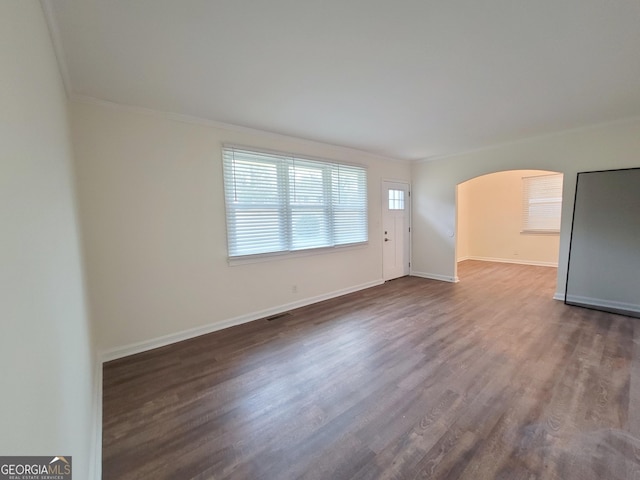 1151 N Beddingfield Dr, Macon, GA 31206 - unfurnished living room with arched walkways, ornamental molding, and dark wood finished floors