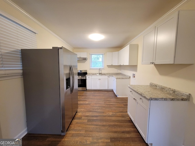 1151 N Beddingfield Dr, Macon, GA 31206 - kitchen with stainless steel appliances, ornamental molding, dark wood finished floors, white cabinetry, and light stone counters
