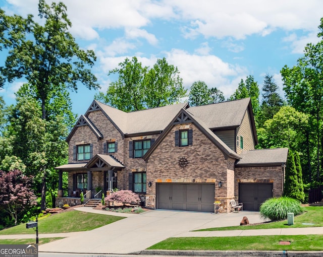 1351 Ashbury Park Dr, Hoschton, GA 30548 - craftsman-style home featuring concrete driveway, a front yard, and stone siding