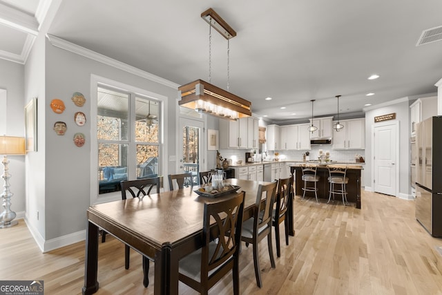 dining room with recessed lighting, baseboards, light wood finished floors, and visible vents