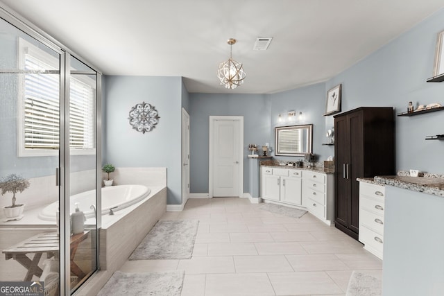 bathroom with visible vents, tile patterned flooring, an inviting chandelier, vanity, and a bath