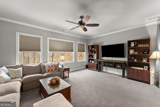 living area featuring crown molding, visible vents, baseboards, a ceiling fan, and carpet