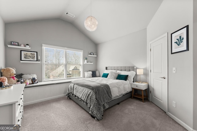 bedroom featuring light colored carpet, visible vents, and lofted ceiling