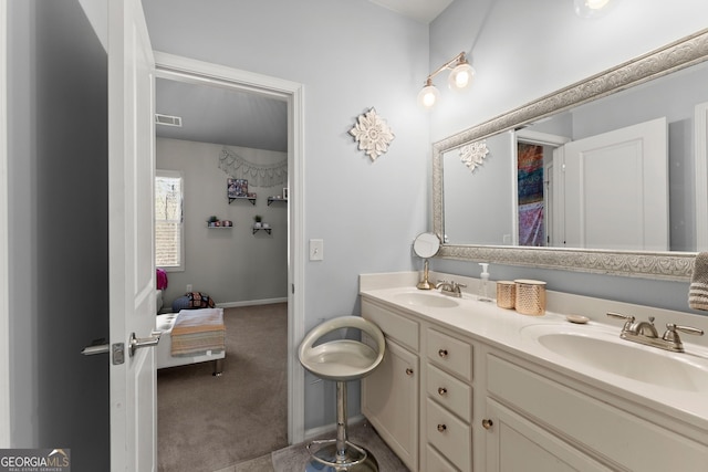 bathroom featuring visible vents, a sink, baseboards, and double vanity