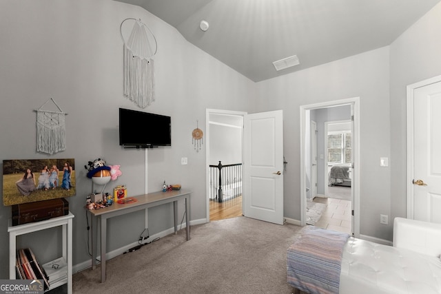 carpeted bedroom with baseboards, visible vents, and lofted ceiling