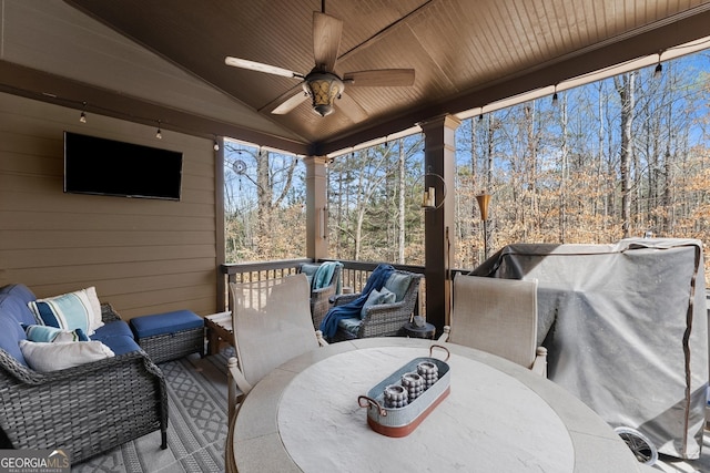wooden terrace featuring outdoor dining area, ceiling fan, and an outdoor hangout area