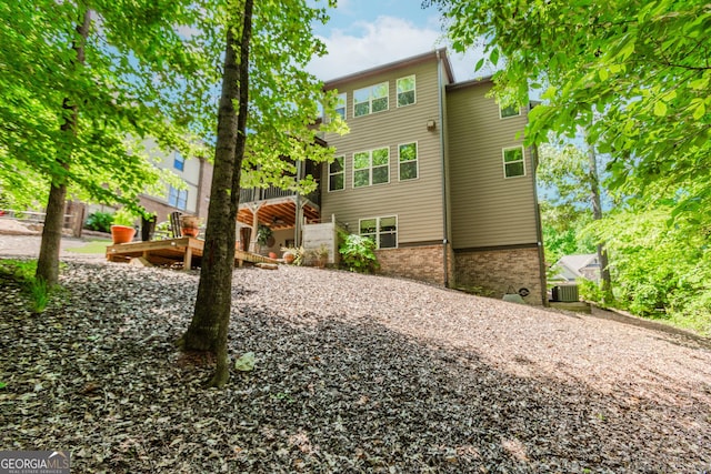 1351 Ashbury Park Dr, Hoschton, GA 30548 - back of house featuring brick siding and a wooden deck