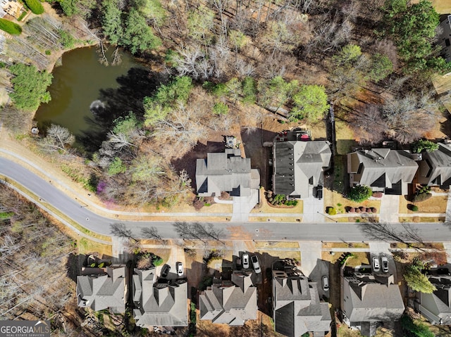 bird's eye view featuring a water view and a residential view