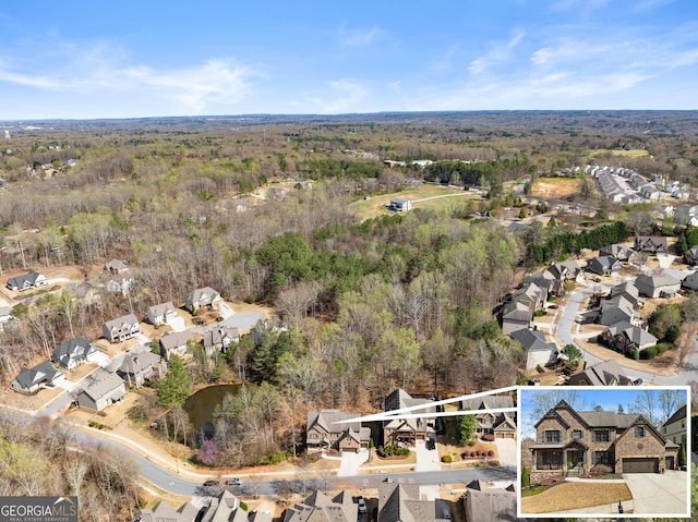 aerial view with a residential view and a wooded view
