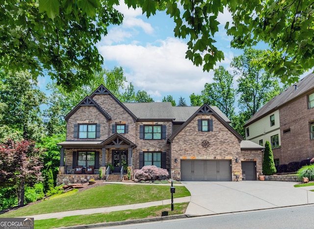 1351 Ashbury Park Dr, Hoschton, GA 30548 - craftsman inspired home with driveway, a front lawn, stone siding, and a garage