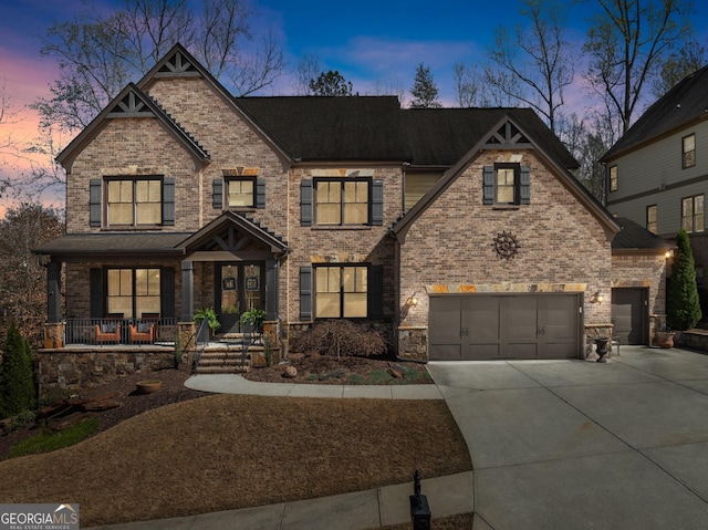 view of front facade featuring covered porch, brick siding, driveway, and a shingled roof