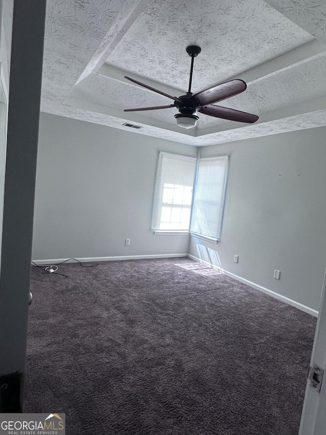 unfurnished room featuring baseboards, carpet, a ceiling fan, and a textured ceiling