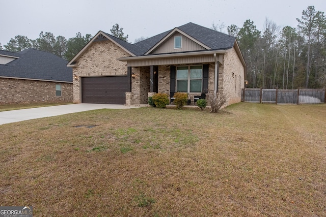 view of front of property with fence, concrete driveway, a front lawn, a garage, and brick siding