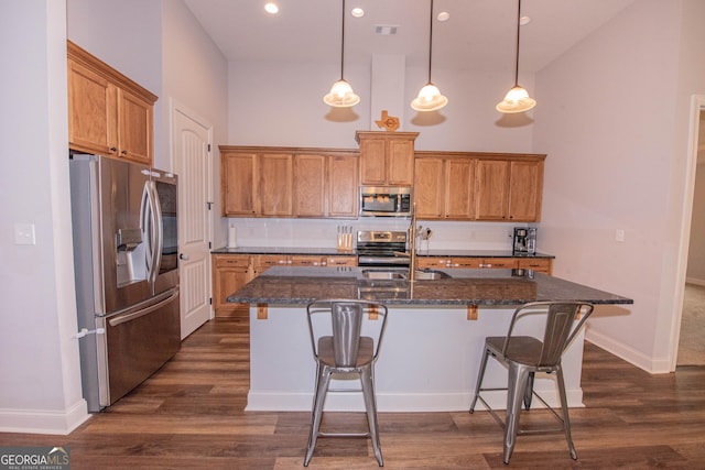 kitchen featuring visible vents, backsplash, appliances with stainless steel finishes, and a high ceiling